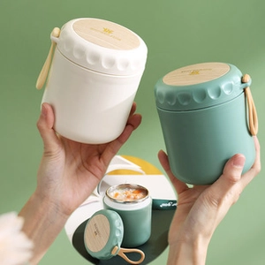 Detail of insulated stainless steel soup cup with wood grain lid and silicone handle