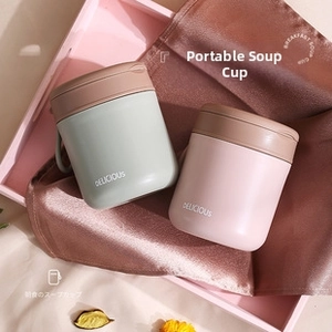 Close-up of portable stainless steel soup mugs in mint green and pale pink colors