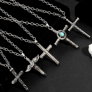 Collection of five vintage gothic cross necklaces on black velvet background
