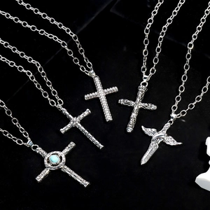 Set of five vintage silver cross pendant necklaces with retro carvings on black velvet