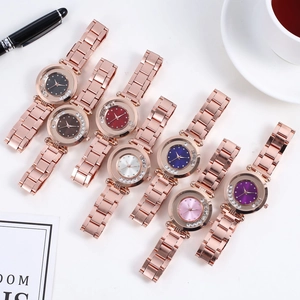 Flat lay of luxury women quartz watches with seven colorful dials and floating crystals
