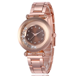 Close-up of rose gold watch with deep brown gradient dial and sliding rhinestones