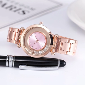 Macro shot of rose gold watch dial featuring floating diamonds and rhinestone markers