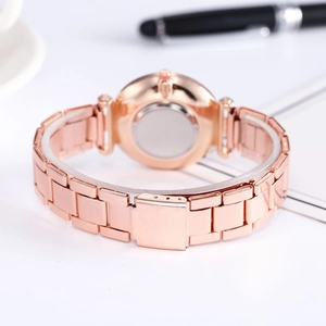 Close-up of rose gold watch steel band with metal folding clasp on white background