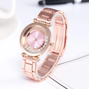 Detail of rose gold watch with floating crystals and pink rhinestone dial