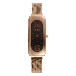 Close-up of rose gold rectangular watch case with black dial and mesh strap