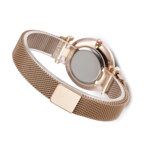 Detail view of rose gold Milanese mesh watch strap and polished stainless steel case back