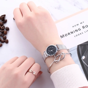 Silver mesh strap watch set with twist bracelet and swirl ring shown on wrist