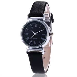 Minimalist quartz watch with black leather strap and Roman numeral dial on white background