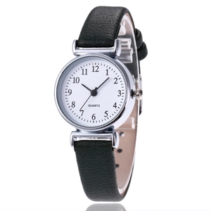 Detail view of a classic silver quartz watch with Arabic numerals and a black leather strap