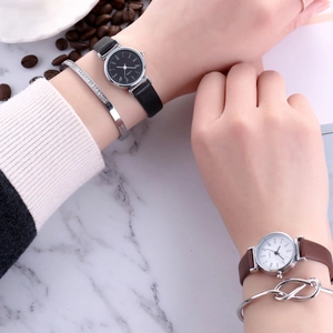 Close-up of elegant women quartz watches with leather straps and bracelets on marble