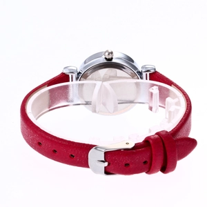 Detail of red leather watch strap with lychee texture and silver metal buckle