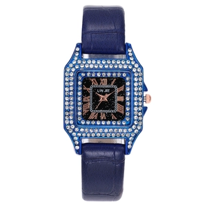 Detail of square quartz watch featuring a crystal bezel and navy blue leather strap