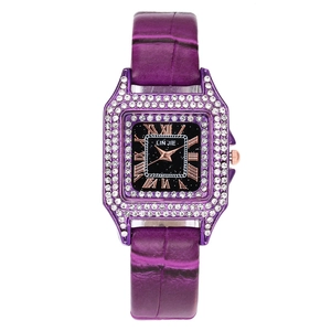 Close-up of purple leather strap watch with rhinestone bezel and Roman numeral dial