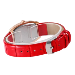 Detail of red faux leather strap with gold case and silver buckle on a tonneau watch
