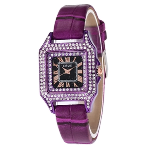 Detail of square quartz watch featuring purple leather strap and crystal bezel with Roman numerals