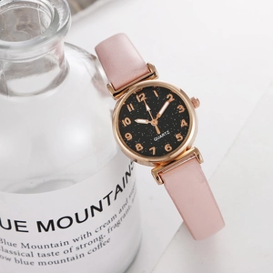 Detail of rose gold ladies watch with starry black dial and pink leather strap