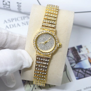Close-up of gold quartz watch with full rhinestone inlay on strap and bezel