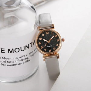 Detailed close-up of a starry sky watch dial with rose gold case and leather strap