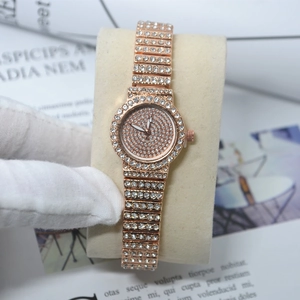 Detailed macro view of iced out rose gold watch with sparkling rhinestones on the band