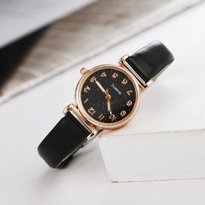 Macro view of starry sky dial with gold numerals and polished rose gold watch case