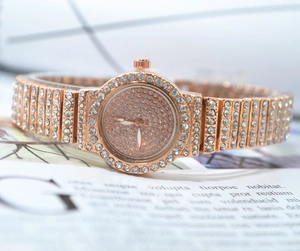 Macro shot of rose gold alloy watch band encrusted with white crystal rhinestones