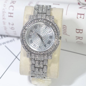 Detail shot of silver iced-out quartz watch with rhinestones and Roman numerals