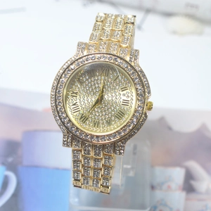 Macro detail of iced-out gold watch featuring Roman numerals and full crystal pavé dial