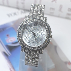 Detailed macro view of luxury silver watch featuring full rhinestones and Roman numerals