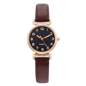 Elegant women's quartz watch with black starry dial and brown leather strap on white backdrop
