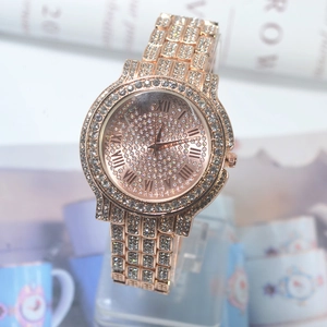 Detail of rose gold luxury watch with full crystal pavé and roman numeral dial