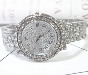 Detail of luxury iced-out watch with crystal-encrusted strap and Roman numeral dial