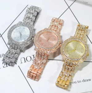 Macro detail of three luxury quartz watches in gold, silver, and rose gold with rhinestones