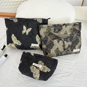Three-piece black makeup bag set with gold and silver butterfly embroidery textures