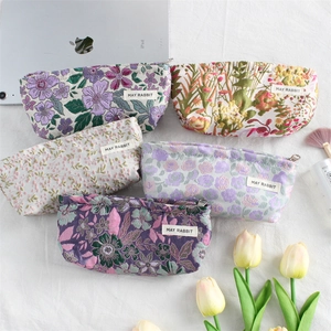 Floral embroidery canvas makeup bags with metal zippers in various pastel patterns