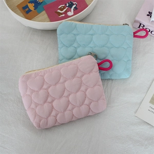 Detailed view of pink and blue quilted heart pouches with pink handles and zip closure