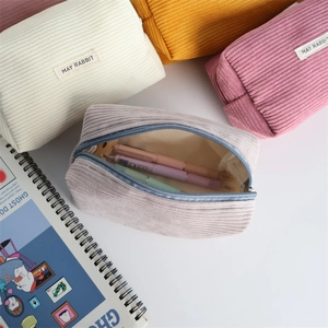 Portable corduroy pencil case in four soft colors with metal zipper and label