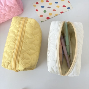 Quilted heart pattern cosmetic bags for stationary storage in pink yellow and white colors