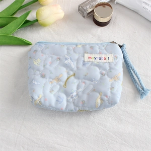 Detailed shot of quilted Cinnamoroll mini pouch with mayrabbit tag and zipper closure