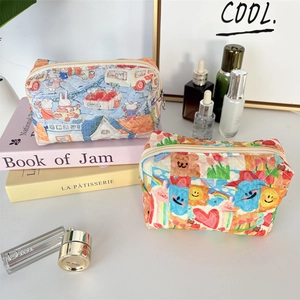 Detailed view of quilted cotton cosmetic bags with cute cartoon prints and zipper closure