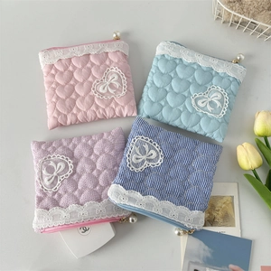 Detail of square lace cosmetic bags with heart quilting and pearl zipper pullers