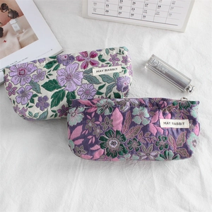 Floral embroidered jacquard makeup bag with May Rabbit label and vintage botanical pattern