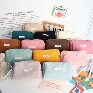 Detailed pile of 13 colorful corduroy pencil pouches showing vibrant fabric textures