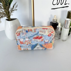 Detailed macro view of quilted makeup bag with cute cartoon rabbit prints and top zipper