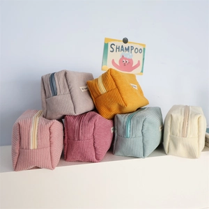 Close-up of colorful corduroy storage bags in pink, purple, and blue tones