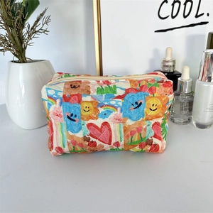 Quilted cosmetic bag detail featuring colorful bear and tulip patterns on desktop