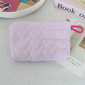 Close-up of pink quilted heart pattern bag with zipper and magenta rope handle