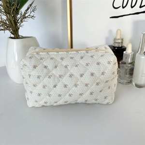 Detailed macro view of quilted floral fabric texture and zipper on makeup bag