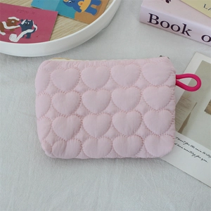 Detailed view of pink quilted heart pouch with drawstring for makeup and essentials