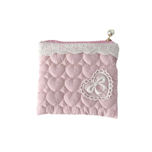 Pink heart-quilted lace coin purse with bow patch and pearl zipper on white background